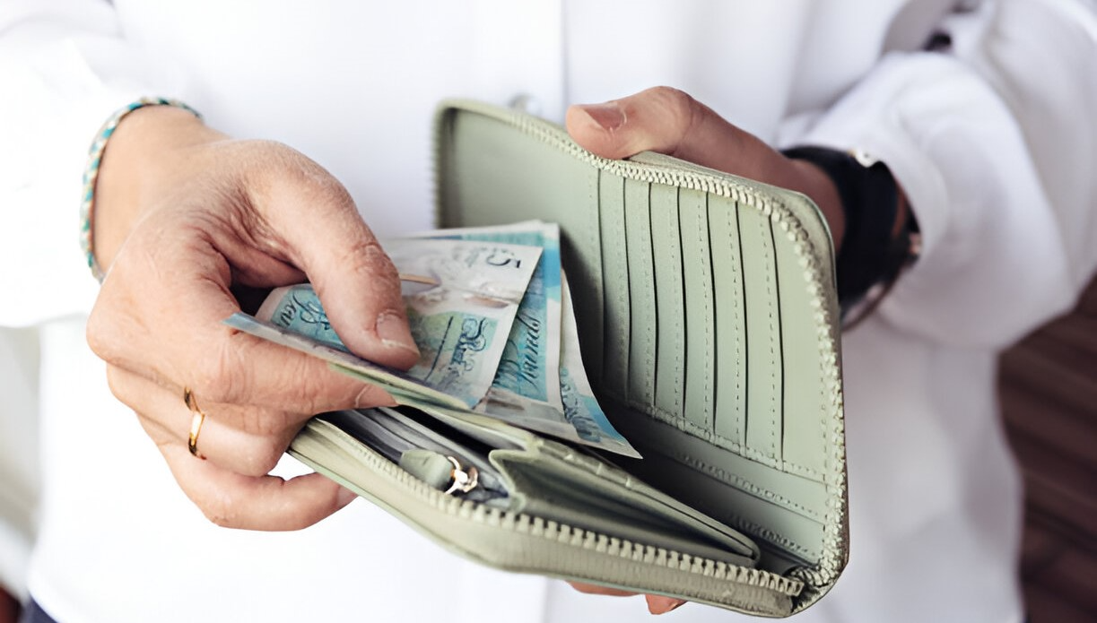 woman counting some Pounds in her wallet